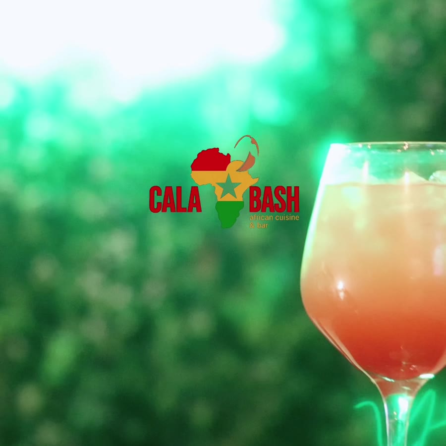 A drink in front of the green wall at Calabash