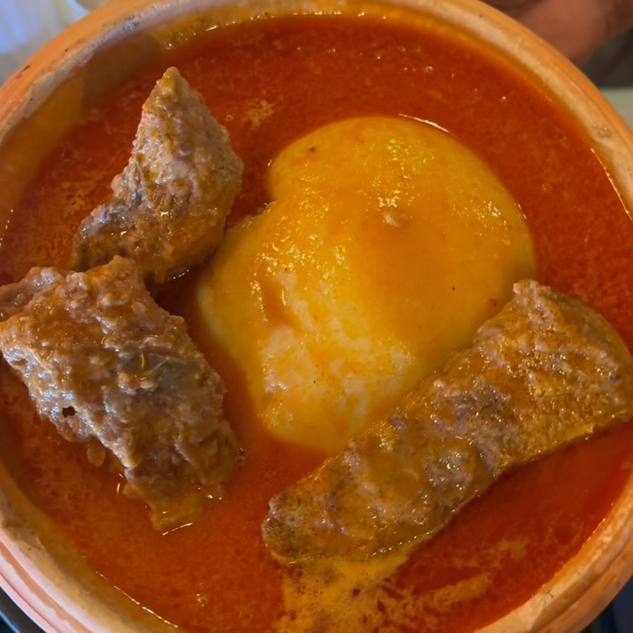 Fufu in tomato light soup with beef, from above